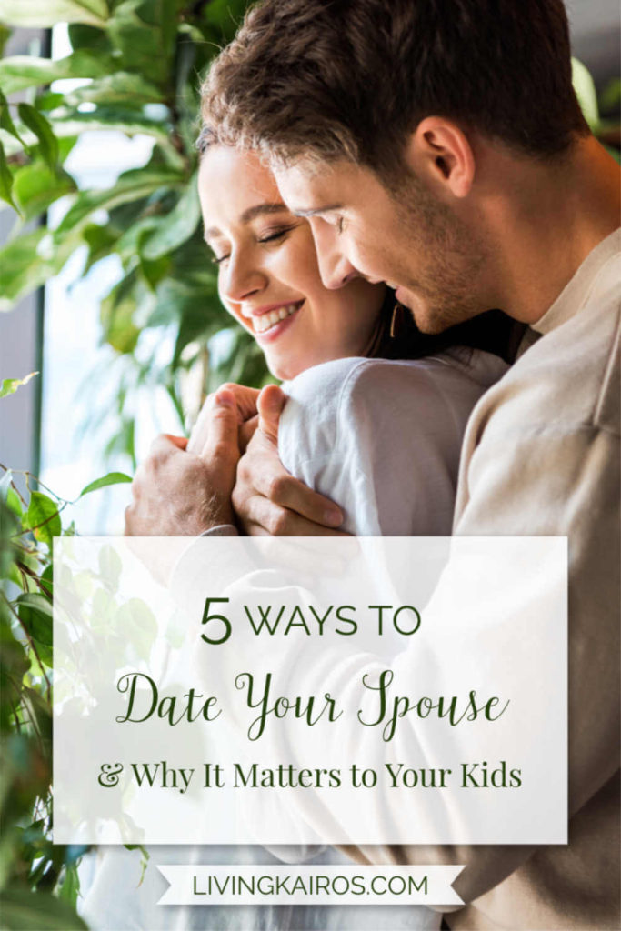 A couple hugging by a window | Five Ways to Date Your Spouse & Why It Matters to Your Kids